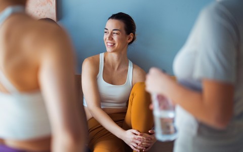 a woman sitting on a couch smiling