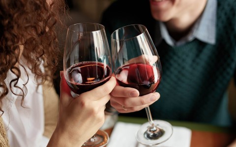 a couple of people holding wine glasses