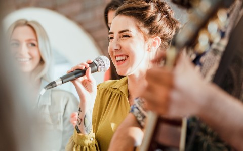 a woman singing into a microphone