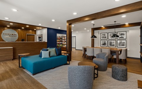 a room with a couch and chairs