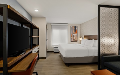 a room with a bed and a tv