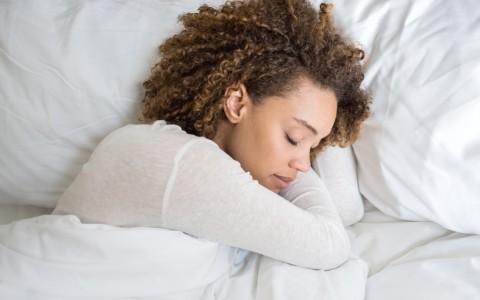 a woman sleeping in bed