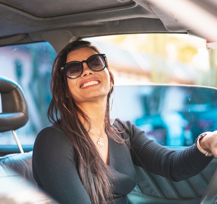 a woman smiling in a car