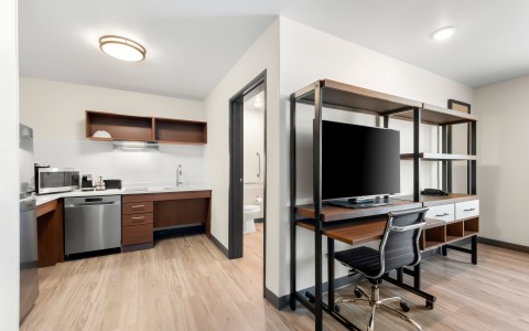 a room with a desk and a computer