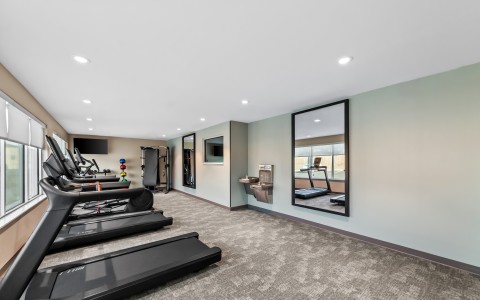 a room with treadmills and exercise equipment