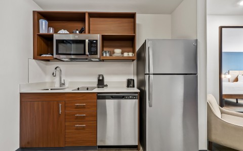 a kitchen with a stainless steel refrigerator and a sink