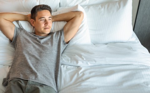a man lying on a bed
