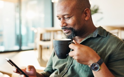 a man holding a cup of coffee