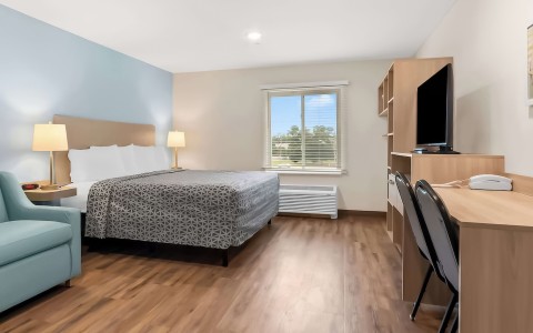 a room with a bed and a tv