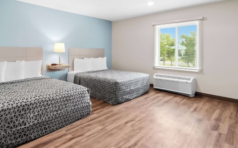 a room with two beds and a window