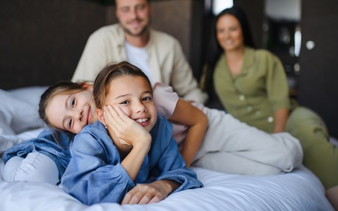 a group of people sitting on a bed
